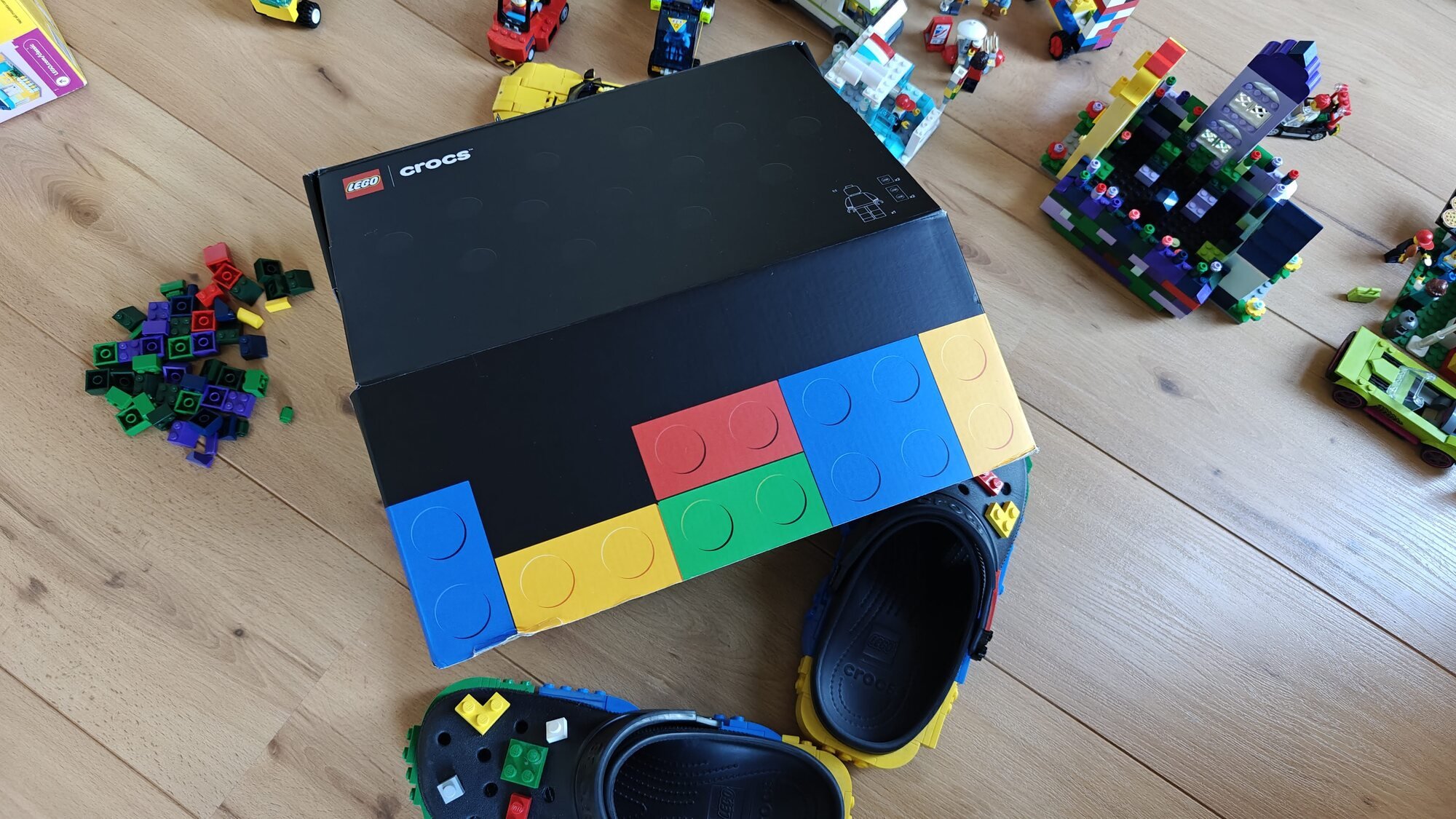 Top view of the shoebox with the two Crocs next to it