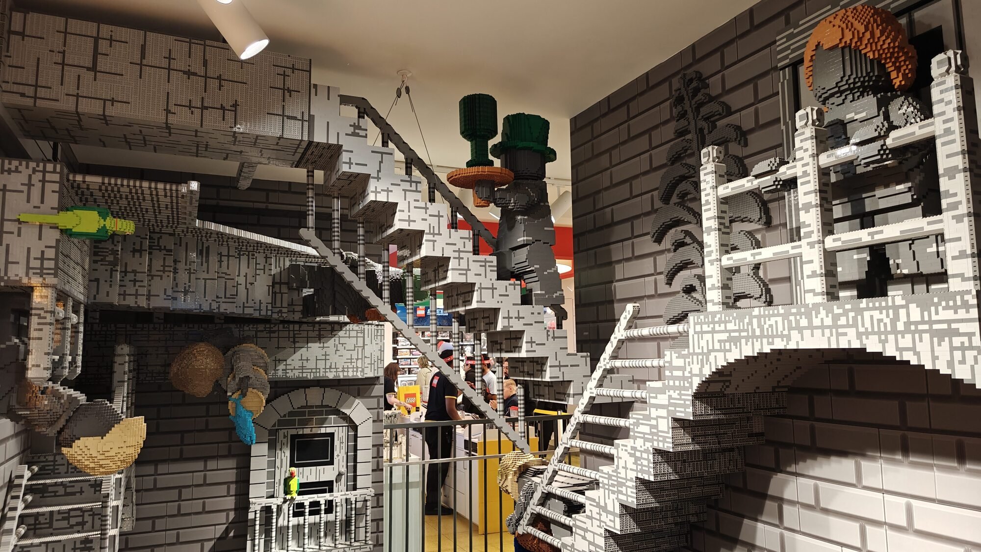 Gray LEGO® models hanging in the stairwell