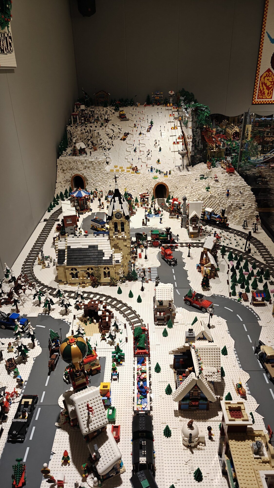 Zoomed-out view of a winter village with ski jump and Christmas trains