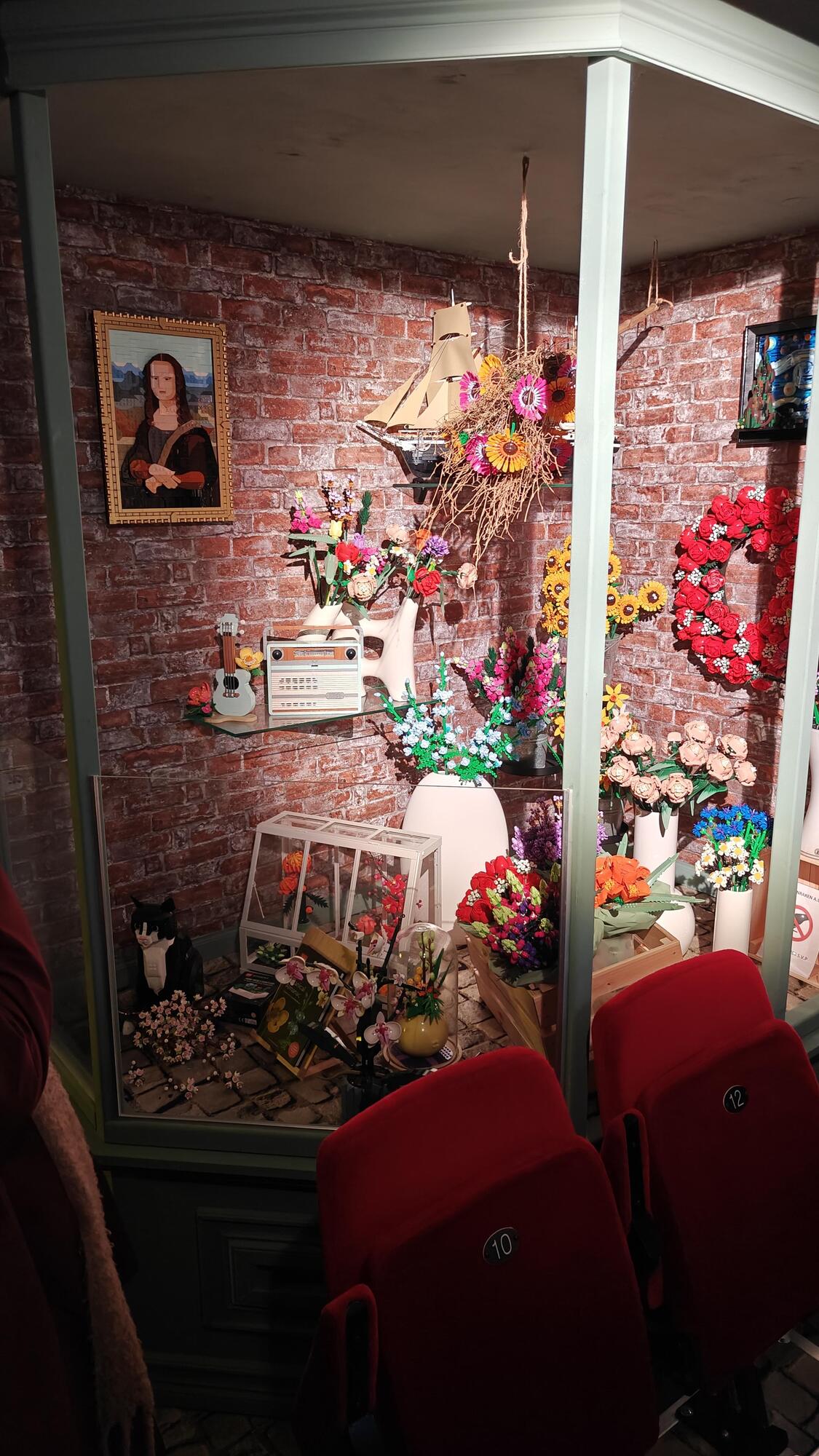 Display with Mona Lisa, ukulele, radio, cat ship, and many botanical sets