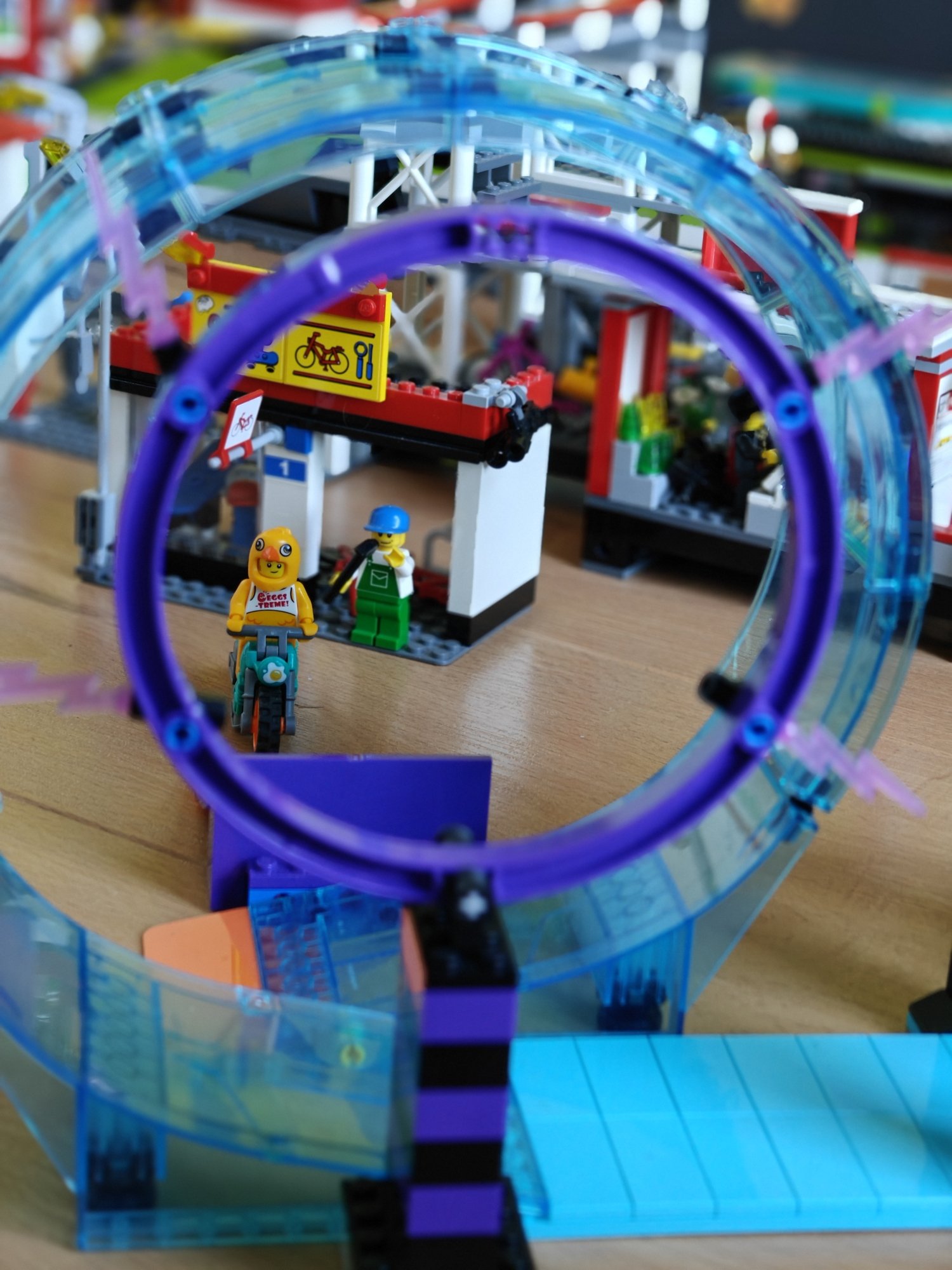 A motorbike with minifig poised to jump through a stunt ring