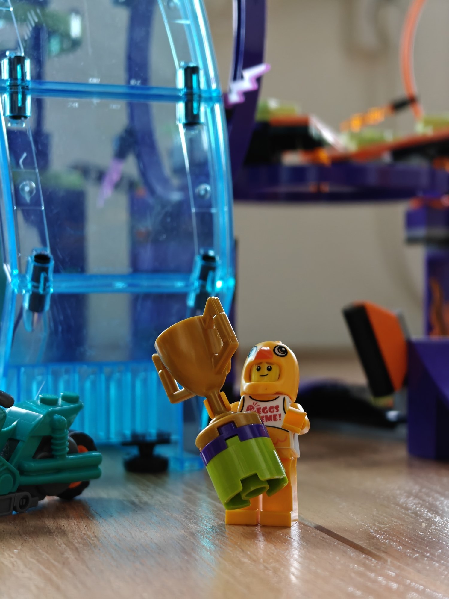 A minifig posing with a trophy as the stunt winner